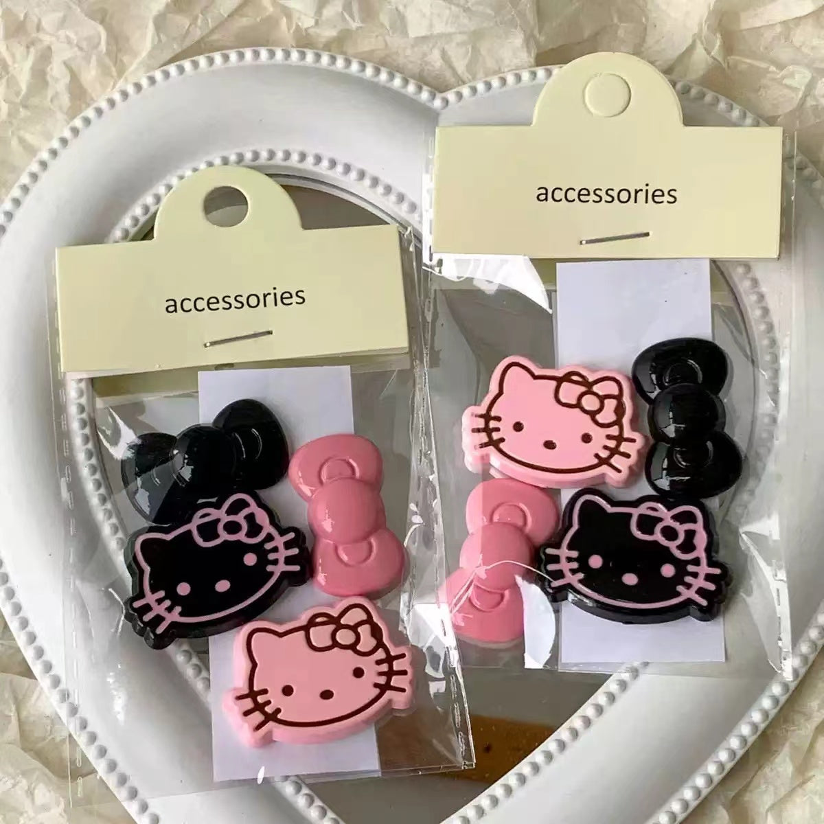 Black and pink Hello kitty charms